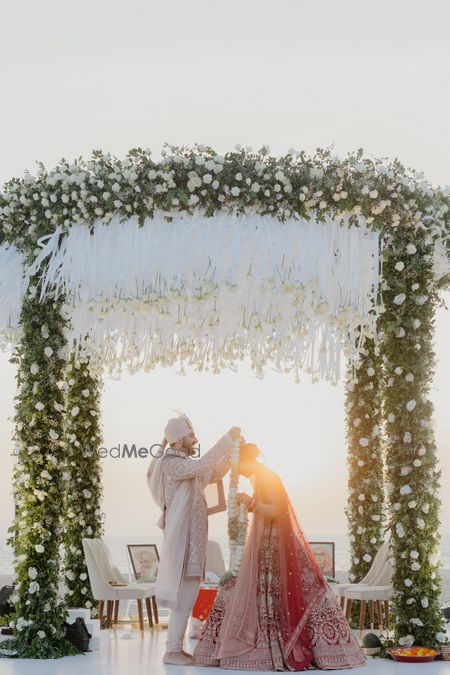 Lovely circular outdoor mandap with white and green floral decor