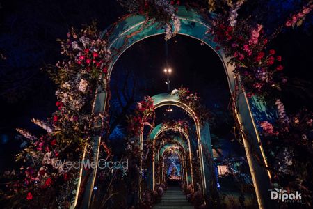 Arch ways lit up with gorgeous lights and floral decor for the sangeet night