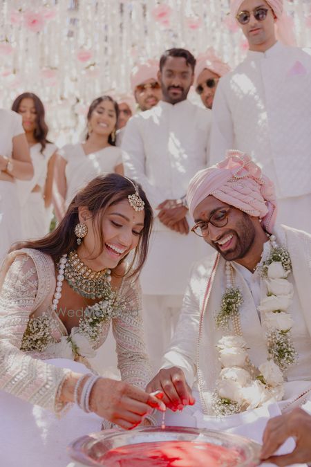 Candid couple portrait as they play wedding games on their wedding day with co-ordinated outfits