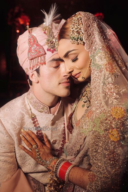 Serene couple shot with the bride in a pastel lehenga and groom in pink safa 