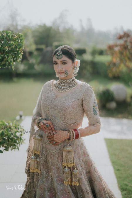 Gorgeous bridal portrait in a pastel lehenga and statement diamond jewellery with emerald detailing